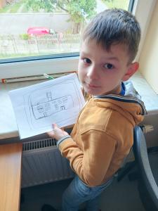 Uczeń rysujący przy oknie